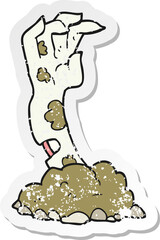retro distressed sticker of a cartoon zombie hand rising from ground