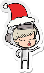 sticker cartoon of a pretty astronaut girl wearing santa hat