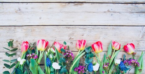 tulips on wooden background - beautiful bouquet of spring flowers on rustic wooden board - easter...