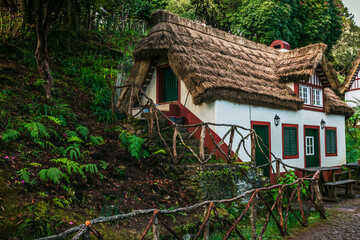 Taditional houses in Queimadas Forest Park in Santana, Madeira near Caldeirao Verde waterfall, Portugal.