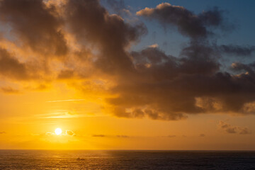 Fototapeta na wymiar Seascape at sunset - yellow sun is setting down on the horizon