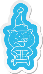 cartoon  sticker of a pig with christmas present wearing santa hat
