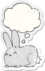 cartoon rabbit and thought bubble as a distressed worn sticker