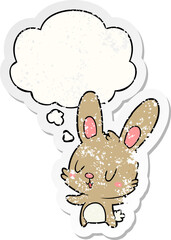 cute cartoon rabbit and thought bubble as a distressed worn sticker