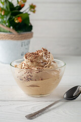 Coffee mousse dessert with cream on white table