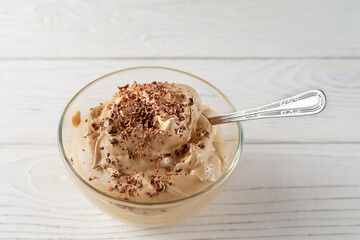 Coffee mousse dessert with cream on white table