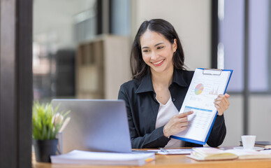 Portrait of business asian woman working on laptop in her workplace. asian smile business lady employee working on laptop in office finance business concept.