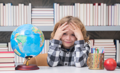 Tired and bored pupil. School kid student learning, study language or literature at school....