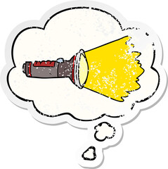 cartoon electric torch and thought bubble as a distressed worn sticker