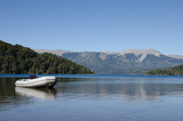 motorized rubber boat, parked on the shores of a lake in patagonia