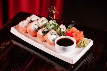Sushi roll set with salmon and caviar side view.