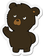 sticker of a cartoon waving black bear
