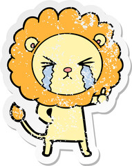 distressed sticker of a cartoon crying lion