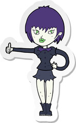 sticker of a cartoon vampire girl giving thumbs up sign