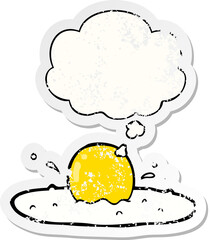 cartoon fried egg and thought bubble as a distressed worn sticker