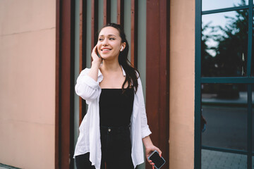 Smiling woman listening to songs from playlist