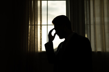 Sad man with laptop got migraine touches her head because of pain. Man manager with strong...