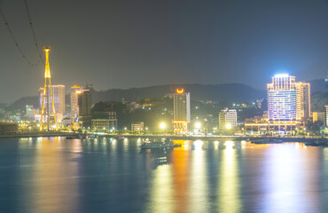 Fototapeta na wymiar Colorful night view of Bai Chay Bridge, connecting two parts of Ha Long City, Hon Gai City and Bai Chay City through Cua Luc Bay.