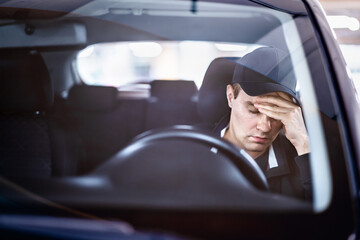 Sad man in car. Accident in traffic. Tired sleepy driver. Sick with headache or migraine. Anxiety, stress, despair or depression. Exhausted after driving. Problem with insurance. Pensive person.
