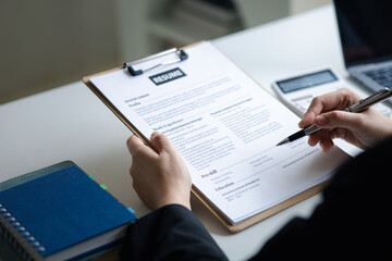 Fototapeta premium Person submitting resume to interview for a job with a company, Person attending a job interview with a manager to be recruited to the company for the position applied for. Job application concept.