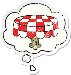 cartoon table and thought bubble as a distressed worn sticker