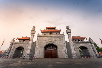 Fototapeta premium Main gate of Hung King Temple, Phu Tho Province, Vietnam. Text on gate in English meaning Hung King temple.