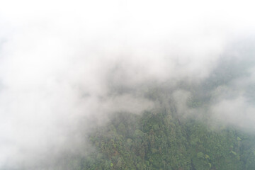 View of rice fields on terraced, hills, forest with misty and fog, view from cable car to Mount Fansipan