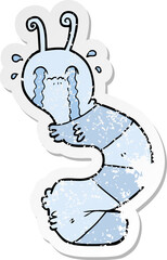 distressed sticker of a cartoon crying caterpillar