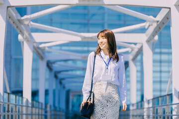 屋外を歩く笑顔を日本人女性ビジネスマン