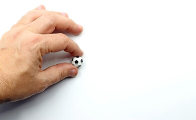 Hand picking up a toy soccer ball