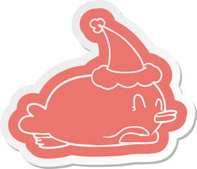 penguin lying on belly wearing santa hat