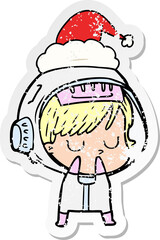 distressed sticker cartoon of a astronaut woman wearing santa hat
