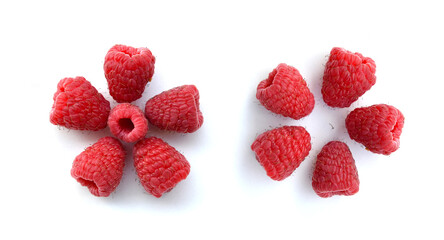 Raspberry berries in the shape of a flower as a set, closeup isolated on a white background. Top view of red sweet juicy berries pattern. Healthy food, ripe delicious summer harvest from Greek garden.