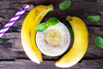 Banana fresh cocktail vanilla smoothies  fruit juice beverage healthy the taste yummy in glass drink episode good morning on wooden background from the top view.