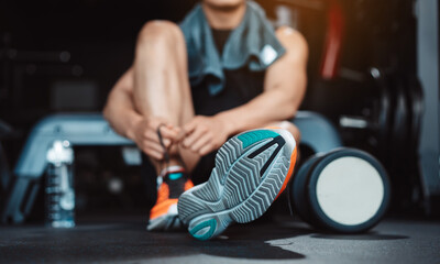 Man exercise workout in gym fitness breaking and resting after training sport with dumbbells and water bottle healthy lifestyle bodybuilding.