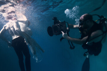 filming a movie underwater underwater cameraman and actors