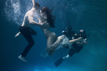 filming a movie underwater underwater cameraman and actors