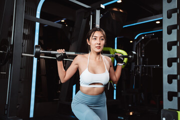 Fototapeta na wymiar Woman working out Bodybuilder with barbell weights at the gym. bodybuilder doing exercises with barbell. training sport healthy lifestyle bodybuilding, Athlete builder muscles lifestyle.