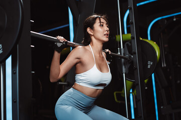 Fototapeta na wymiar Woman working out Bodybuilder with barbell weights at the gym. bodybuilder doing exercises with barbell. training sport healthy lifestyle bodybuilding, Athlete builder muscles lifestyle.