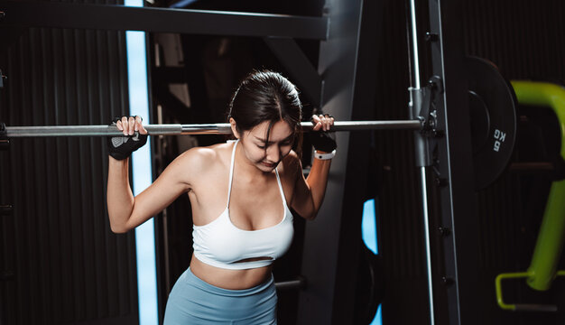 Woman working out Bodybuilder with barbell weights at the gym. bodybuilder doing exercises with barbell. training sport healthy lifestyle bodybuilding, Athlete builder muscles lifestyle.