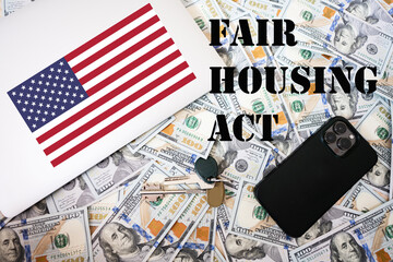Fair housing act concept. USA flag, dollar money with keys, laptop and phone background.