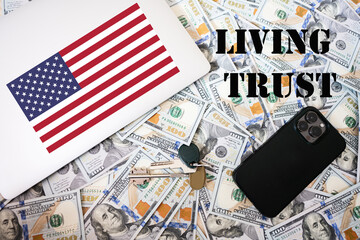Living trust concept. USA flag, dollar money with keys, laptop and phone background.