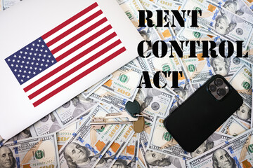 Rent control act concept. USA flag, dollar money with keys, laptop and phone background.