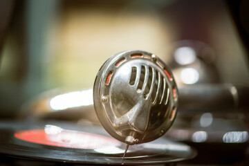 An old gramophone with vinyl records on a  table in a retro style. Vintage. closeup