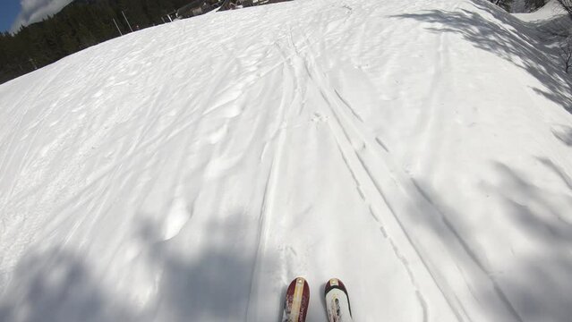 First person view of skiing down a slope in the Alps