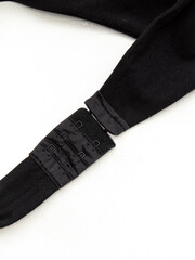 Linen accessories. Closure on the bodysuit. Black clasp on white background