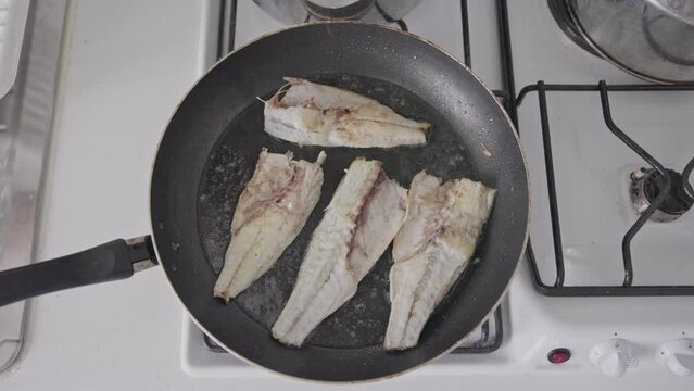 Frying white fish in a frying pan