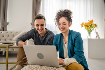 woman and man use laptop computer at home family work leisure concept