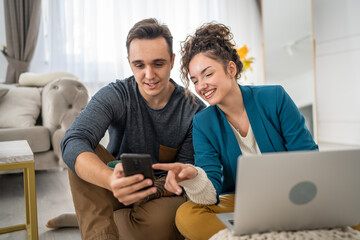 woman and man use mobile phone at home family work leisure concept