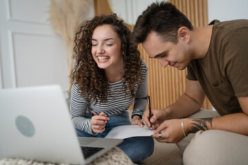 young couple man and woman having online class learn to draw on laptop